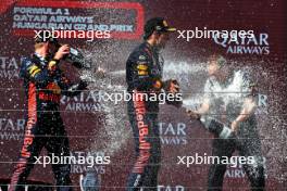 (L to R): Race winner Max Verstappen (NLD) Red Bull Racing celebrates on the podium with second placed team mate Sergio Perez (MEX) Red Bull Racing and Paul Monaghan (GBR) Red Bull Racing Chief Engineer. 23.07.2023. Formula 1 World Championship, Rd 12, Hungarian Grand Prix, Budapest, Hungary, Race Day.