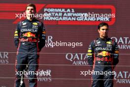 (L to R): Race winner Max Verstappen (NLD) Red Bull Racing on the podium with third placed team mate Sergio Perez (MEX) Red Bull Racing. 23.07.2023. Formula 1 World Championship, Rd 12, Hungarian Grand Prix, Budapest, Hungary, Race Day.