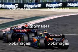 Max Verstappen (NLD) Red Bull Racing RB19 leads Lewis Hamilton (GBR) Mercedes AMG F1 W14 and Lando Norris (GBR) McLaren MCL60 at the start of the race. 23.07.2023. Formula 1 World Championship, Rd 12, Hungarian Grand Prix, Budapest, Hungary, Race Day.