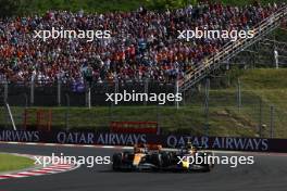 Sergio Perez (MEX) Red Bull Racing RB19 and Oscar Piastri (AUS) McLaren MCL60 battle for position. 23.07.2023. Formula 1 World Championship, Rd 12, Hungarian Grand Prix, Budapest, Hungary, Race Day.