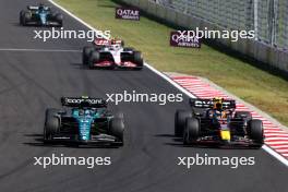 Fernando Alonso (ESP) Aston Martin F1 Team AMR23 and Sergio Perez (MEX) Red Bull Racing RB19 battle for position. 23.07.2023. Formula 1 World Championship, Rd 12, Hungarian Grand Prix, Budapest, Hungary, Race Day.