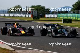 Sergio Perez (MEX) Red Bull Racing RB19 and Lewis Hamilton (GBR) Mercedes AMG F1 W14 battle for position. 23.07.2023. Formula 1 World Championship, Rd 12, Hungarian Grand Prix, Budapest, Hungary, Race Day.