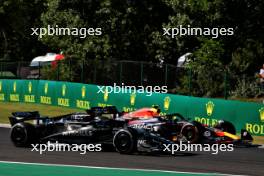 George Russell (GBR) Mercedes AMG F1 W14 and Sergio Perez (MEX) Red Bull Racing RB19 battle for position. 23.07.2023. Formula 1 World Championship, Rd 12, Hungarian Grand Prix, Budapest, Hungary, Race Day.