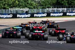 Sergio Perez (MEX) Red Bull Racing RB19 and Valtteri Bottas (FIN) Alfa Romeo F1 Team C43 at the start of the race. 23.07.2023. Formula 1 World Championship, Rd 12, Hungarian Grand Prix, Budapest, Hungary, Race Day.