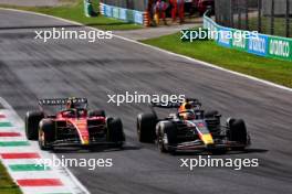 Max Verstappen (NLD) Red Bull Racing RB19 passes Carlos Sainz Jr (ESP) Ferrari SF-23 to lead the race. 03.09.2023. Formula 1 World Championship, Rd 15, Italian Grand Prix, Monza, Italy, Race Day.