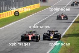 Carlos Sainz Jr (ESP) Ferrari SF-23 and Max Verstappen (NLD) Red Bull Racing RB19 battle for the lead of the race. 03.09.2023. Formula 1 World Championship, Rd 15, Italian Grand Prix, Monza, Italy, Race Day.