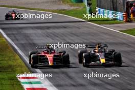 Max Verstappen (NLD) Red Bull Racing RB19 passes Carlos Sainz Jr (ESP) Ferrari SF-23 to lead the race. 03.09.2023. Formula 1 World Championship, Rd 15, Italian Grand Prix, Monza, Italy, Race Day.