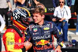 Carlos Sainz Jr (ESP) Ferrari celebrates his pole position in qualifying parc ferme with Max Verstappen (NLD) Red Bull Racing. 02.09.2023. Formula 1 World Championship, Rd 15, Italian Grand Prix, Monza, Italy, Qualifying Day.