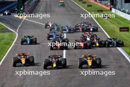 (L to R): Oscar Piastri (AUS) McLaren MCL60; Max Verstappen (NLD) Red Bull Racing RB19; and Lando Norris (GBR) McLaren MCL60 lead at the start of the race. 24.09.2023. Formula 1 World Championship, Rd 17, Japanese Grand Prix, Suzuka, Japan, Race Day.