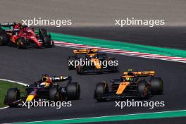 (L to R): Max Verstappen (NLD) Red Bull Racing RB19 and Lando Norris (GBR) McLaren MCL60 battle for position at the start of the race. 24.09.2023. Formula 1 World Championship, Rd 17, Japanese Grand Prix, Suzuka, Japan, Race Day.