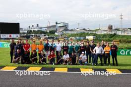 A drivers' and team personnel group photograph with Sebastian Vettel (GER) - Bee Hotel at Buzzin' Corner.  21.09.2023. Formula 1 World Championship, Rd 17, Japanese Grand Prix, Suzuka, Japan, Preparation Day.
