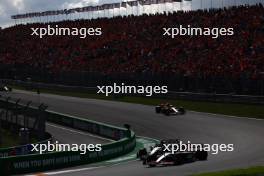 Kevin Magnussen (DEN) Haas VF-23 and Yuki Tsunoda (JPN) AlphaTauri AT04 battle for position. 27.08.2023. Formula 1 World Championship, Rd 14, Dutch Grand Prix, Zandvoort, Netherlands, Race Day.