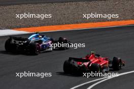 Pierre Gasly (FRA) Alpine F1 Team A523 and Carlos Sainz Jr (ESP) Ferrari SF-23 battle for position. 27.08.2023. Formula 1 World Championship, Rd 14, Dutch Grand Prix, Zandvoort, Netherlands, Race Day.