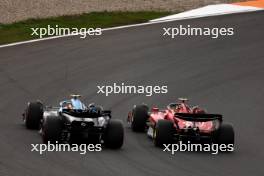 Carlos Sainz Jr (ESP) Ferrari SF-23 and Pierre Gasly (FRA) Alpine F1 Team A523 battle for position. 27.08.2023. Formula 1 World Championship, Rd 14, Dutch Grand Prix, Zandvoort, Netherlands, Race Day.