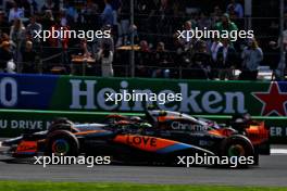 Lando Norris (GBR) McLaren MCL60 and Yuki Tsunoda (JPN) AlphaTauri AT04 battle for position. 27.08.2023. Formula 1 World Championship, Rd 14, Dutch Grand Prix, Zandvoort, Netherlands, Race Day.