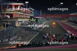 Max Verstappen (NLD) Red Bull Racing RB19 leads at the start of the race as George Russell (GBR) Mercedes AMG F1 W14 and Lewis Hamilton (GBR) Mercedes AMG F1 W14 collide. 08.10.2023. Formula 1 World Championship, Rd 18, Qatar Grand Prix, Doha, Qatar, Race Day.