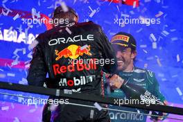 Fernando Alonso (ESP) Aston Martin F1 Team celebrates his third position with Max Verstappen (NLD) Red Bull Racing on the podium. 19.03.2023. Formula 1 World Championship, Rd 2, Saudi Arabian Grand Prix, Jeddah, Saudi Arabia, Race Day.