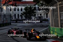 Sergio Perez (MEX) Red Bull Racing RB19 and Carlos Sainz Jr (ESP) Ferrari SF-23. 15.09.2023. Formula 1 World Championship, Rd 16, Singapore Grand Prix, Marina Bay Street Circuit, Singapore, Practice Day.