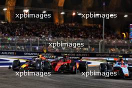 Max Verstappen (NLD) Red Bull Racing RB19 and Carlos Sainz Jr (ESP) Ferrari SF-23 battle for position. 17.09.2023. Formula 1 World Championship, Rd 16, Singapore Grand Prix, Marina Bay Street Circuit, Singapore, Race Day.