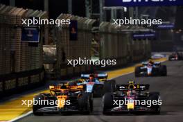 (L to R): Oscar Piastri (AUS) McLaren MCL60 and Sergio Perez (MEX) Red Bull Racing RB19. 17.09.2023. Formula 1 World Championship, Rd 16, Singapore Grand Prix, Marina Bay Street Circuit, Singapore, Race Day.