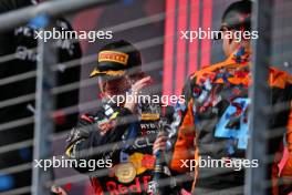 Race winner Max Verstappen (NLD) Red Bull Racing celebrates on the podium with third placed Lando Norris (GBR) McLaren. 22.10.2023. Formula 1 World Championship, Rd 19, United States Grand Prix, Austin, Texas, USA, Race Day.