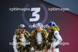 (L to R): Earl Bamber (NZL), Alex Lynn (GBR), Richard Westbrook (GBR) #02 Cadillac Racing, third position, on the podium. 11.06.2023. FIA World Endurance Championship, Le Mans 24 Hours Race, Le Mans, France, Sunday.